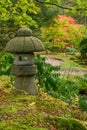 Traditional pagoda inspired stone lantern in Japanese garden in autumn when days shorten Royalty Free Stock Photo